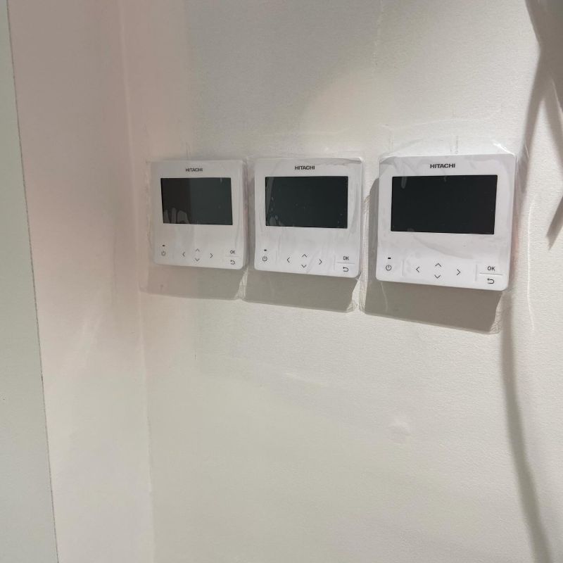 Three air conditioning wall controllers mounted side by side