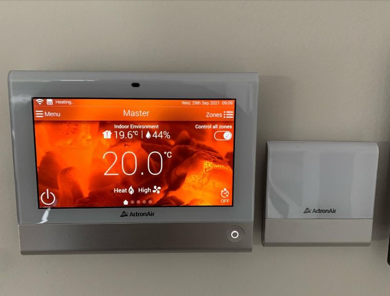 ActronAir touchscreen controller showing heating at 20 degrees
