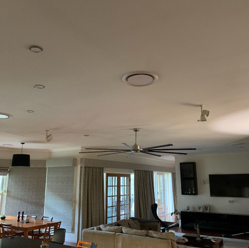 Round ducted air conditioning vent in an open-plan living and dining room
