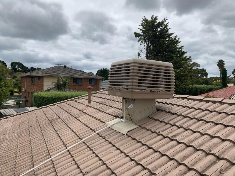 Evaporative cooler on a terracotta tiled roof