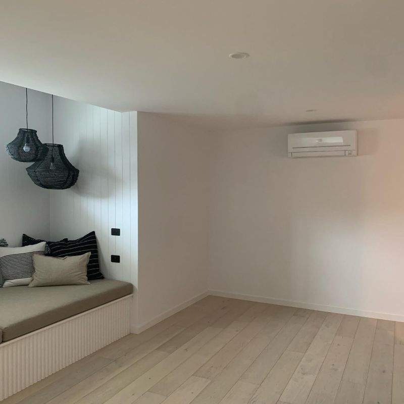 Split system air conditioner in a room with a built-in bench seat