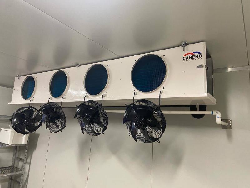 Large four-fan cool room evaporator on a white panel wall